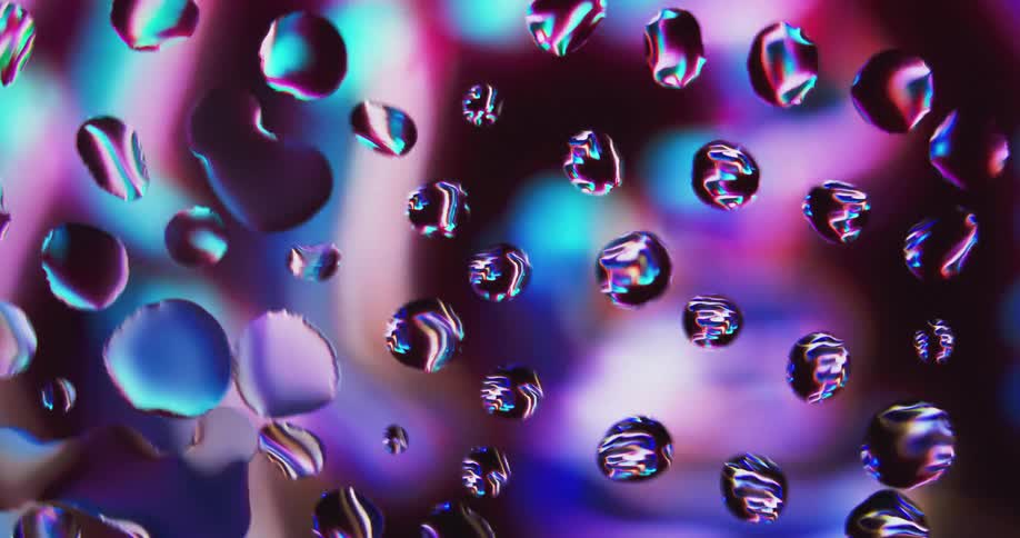 Water droplets with colorful reflections in the back