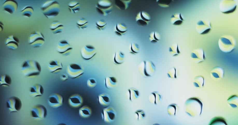 Water droplets with colors moving behind them lighting them up
