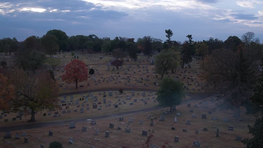 A cemetery is lined with tombstones below
