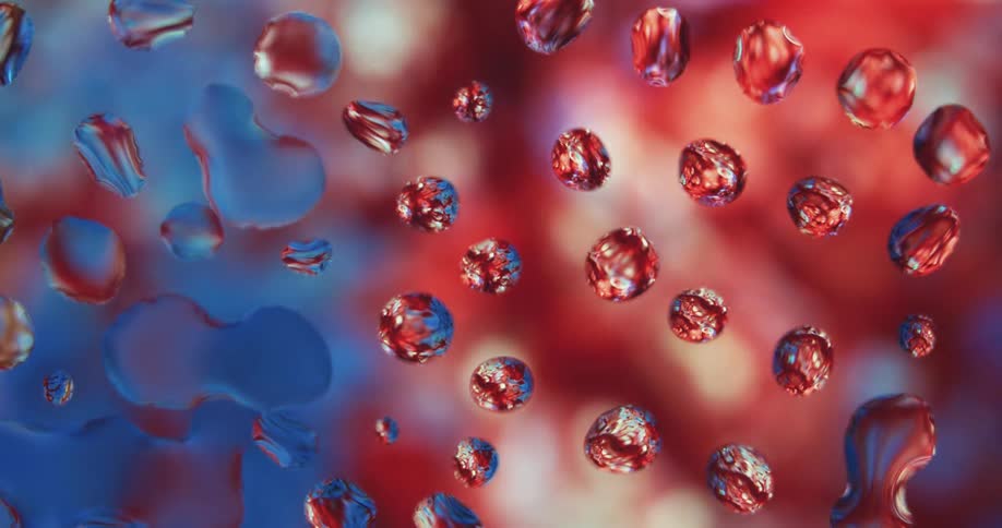Water droplets sit on clear glass as colored lights move in the distance reflecting texture on the spheres