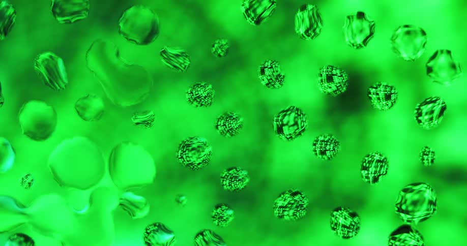 Water droplets sit on clear glass as green lights move in the distance reflecting on the drops