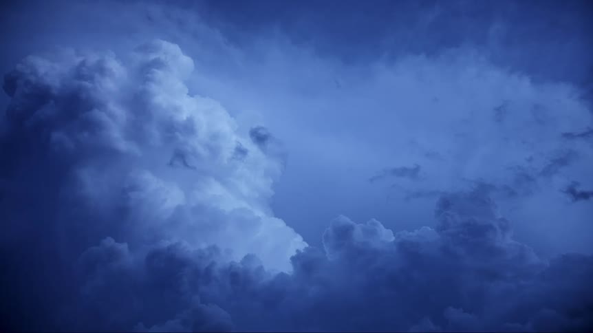 Lightning flashes inside of storm clouds as they move across the sky