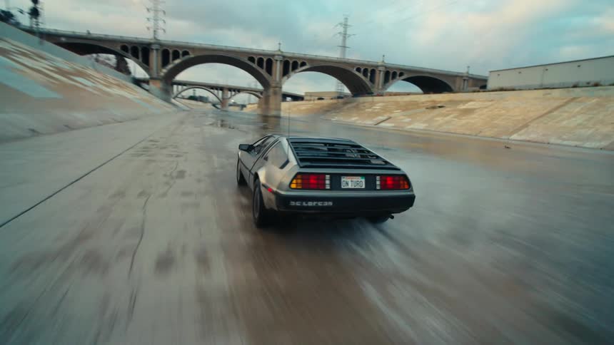 Delorean speeding across a flood control channel
