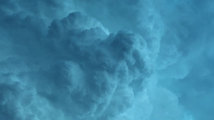Dense fluffy clouds fill the sky at dusk