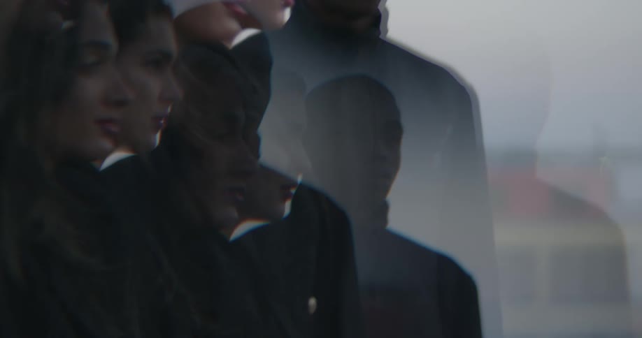 Images of three standing people are superimposed on each other