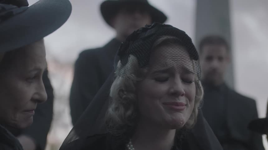 People mourn at a funeral