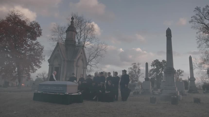 People gathered in a cemetery during the day