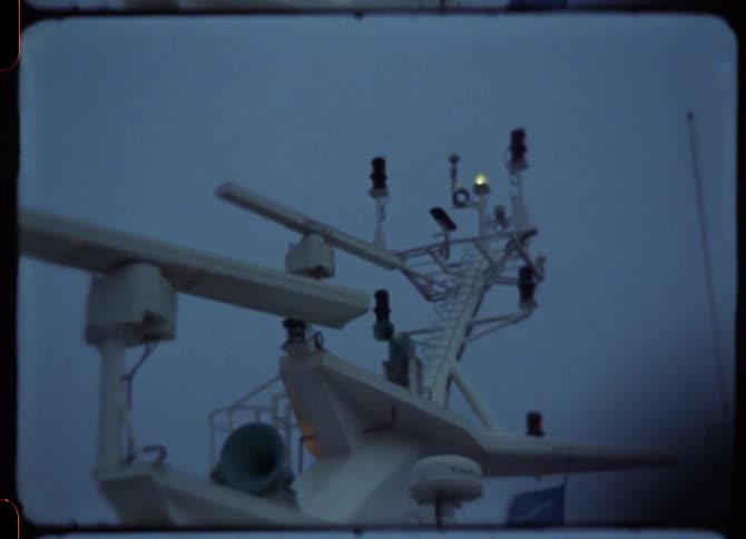 Radar rotates on ship under a blue sky