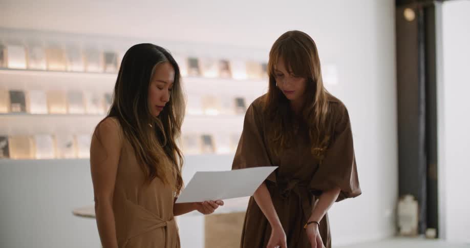 Two women standing in shop with stone samples compare different stones