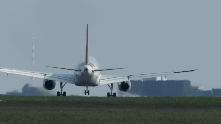 An airplane flies in and lands