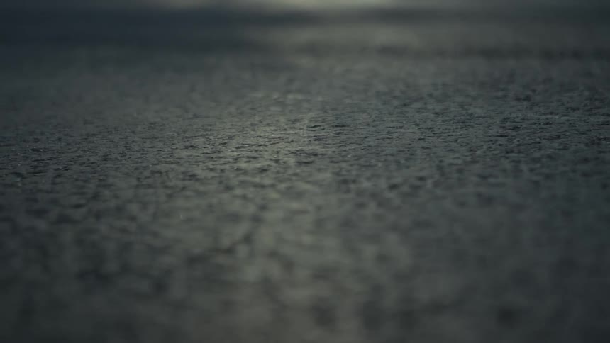 Close up of the concrete texture of the ground reflecting light