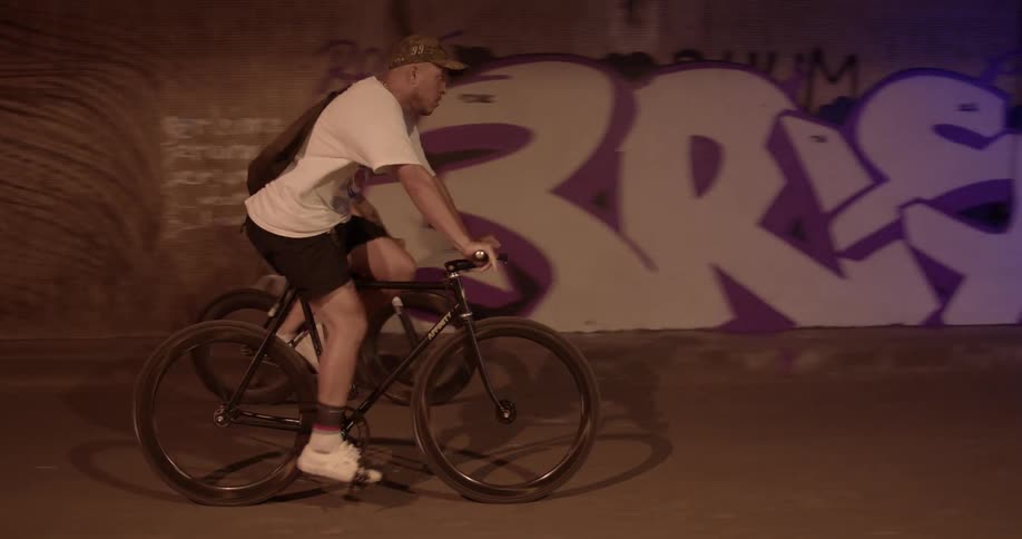 Two people are riding there bike outdoors at night time