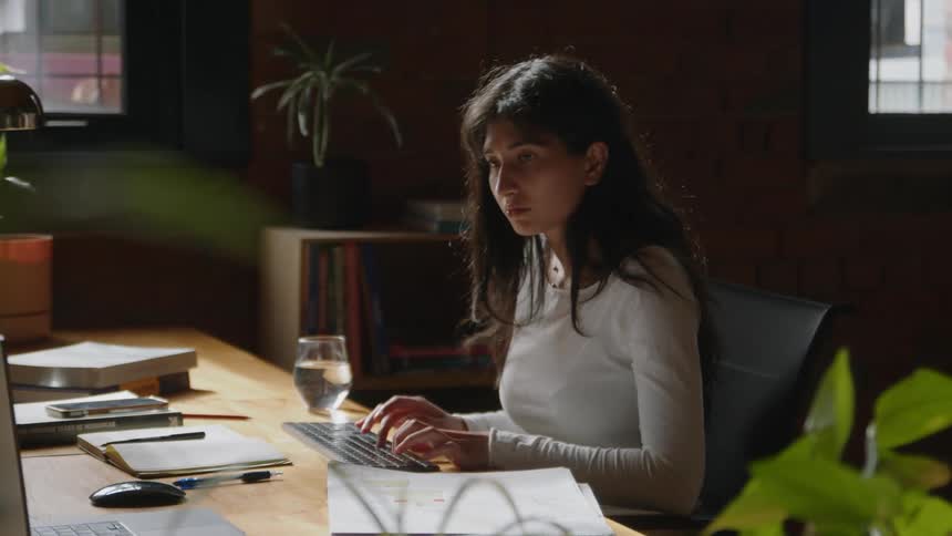 A woman working on her keyboard and doing a job