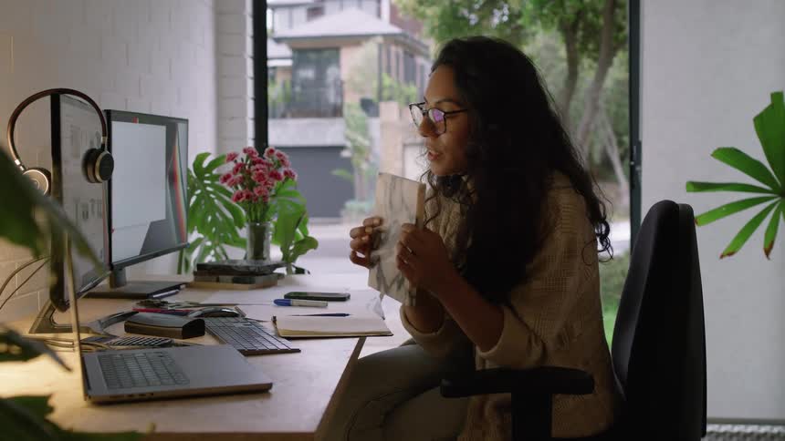 A young woman is working inside of her office in the day time
