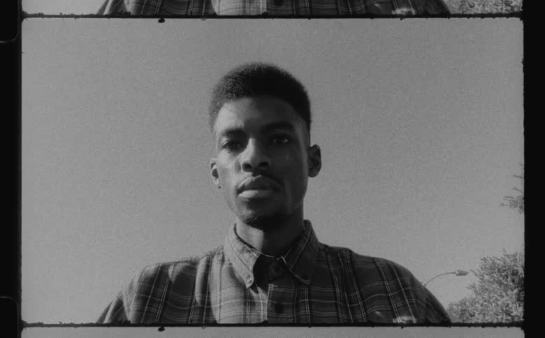 A man looks up while sitting outside