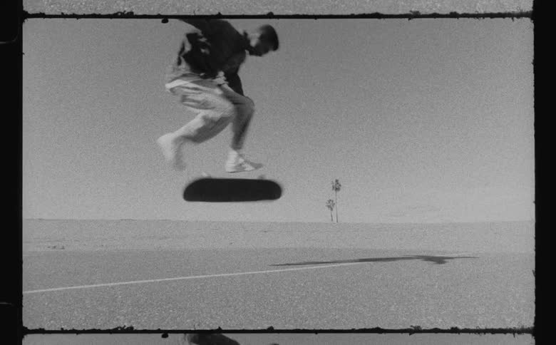 A teenager does a jump on his skateboard