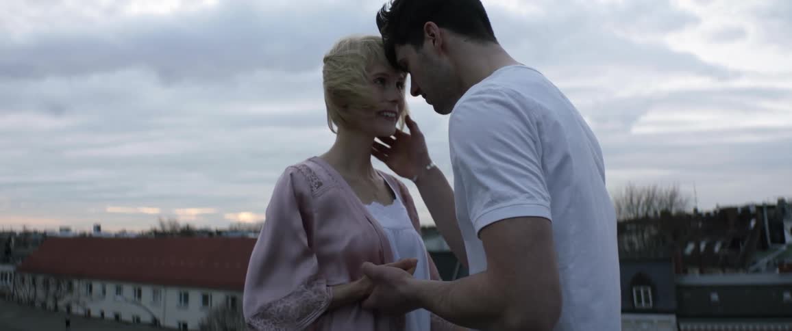 An overcast sky with two people