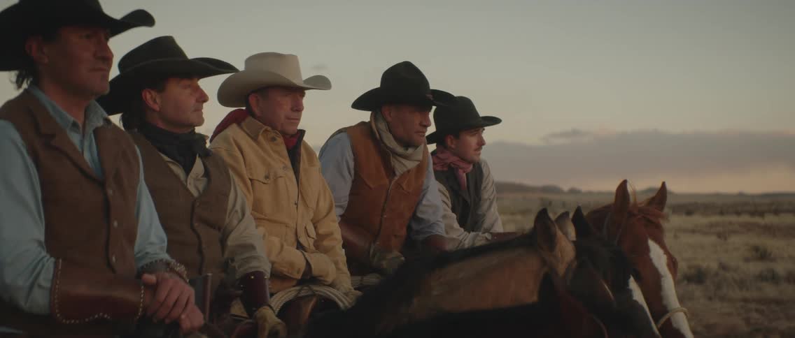 Five men are riding on a horse around the farm area