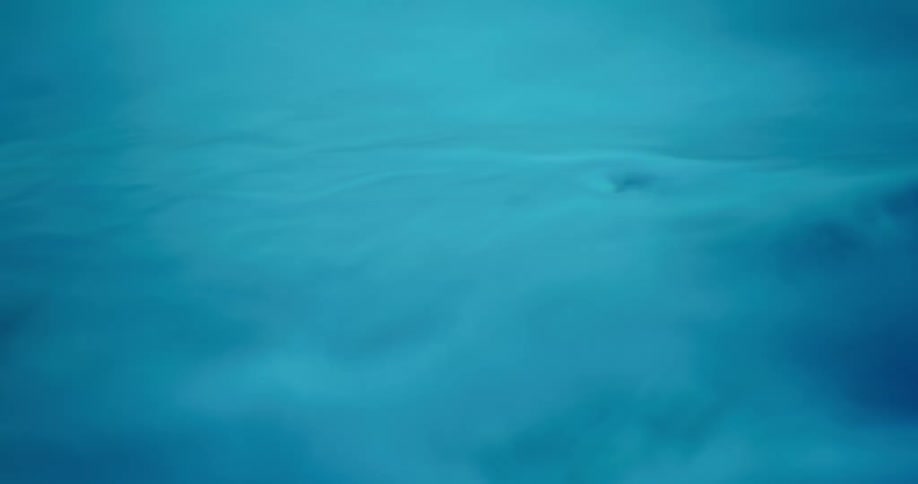 An up close of blue water rippling and moving smoothly