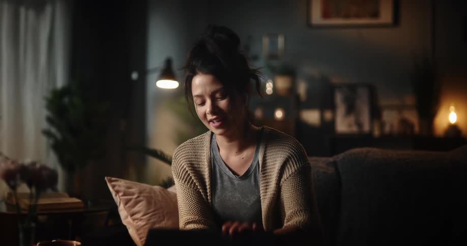 A woman is sitting on a couch and smiling