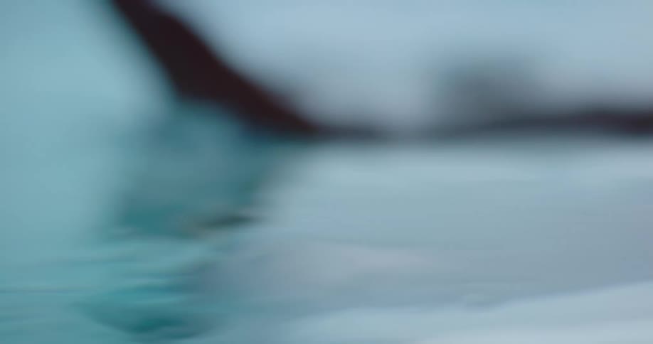 A hand dips underwater