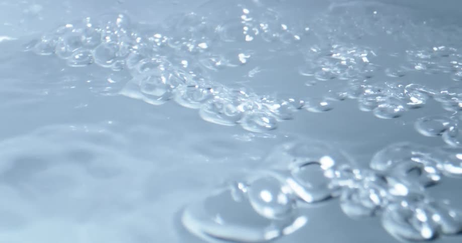 Water bubbles flowing forward creating ripples