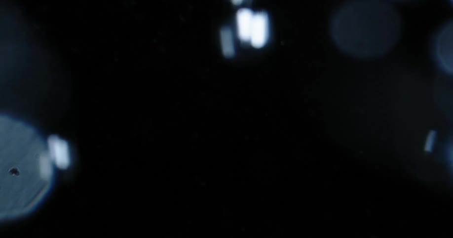 Water bubbles flowing upward on a dark background