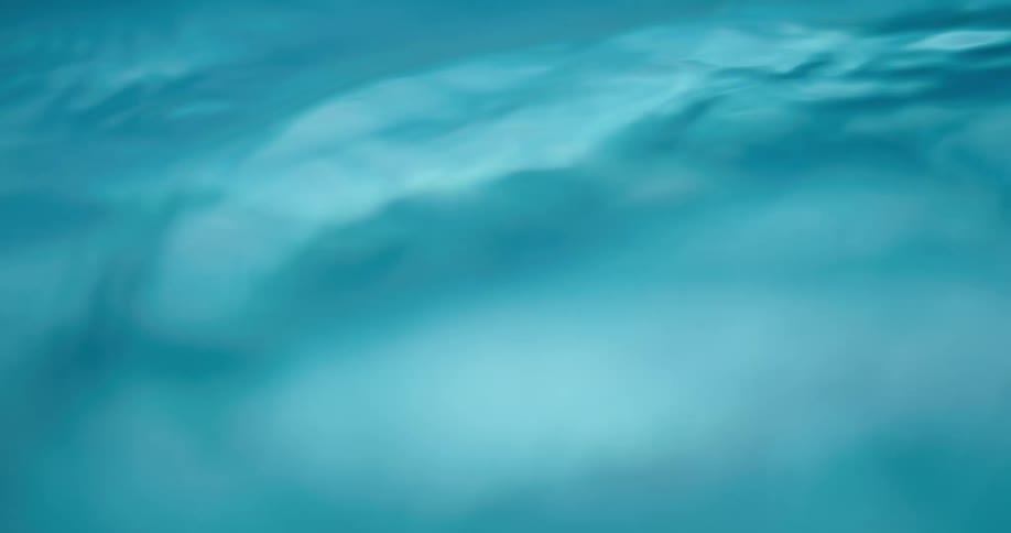 Close up of small ripples and waves on the surface of a body of clear water