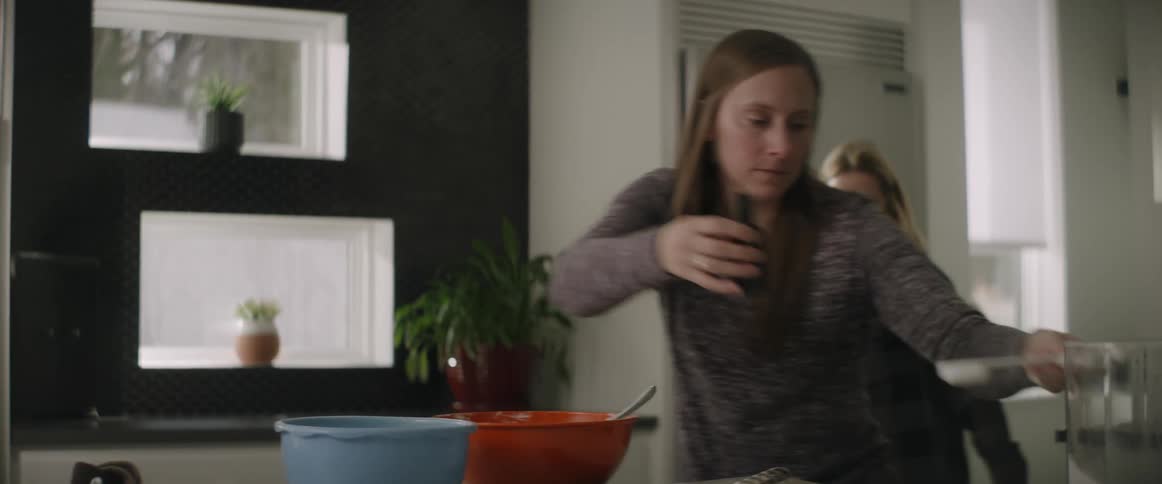 A woman is cooking in the kitchen