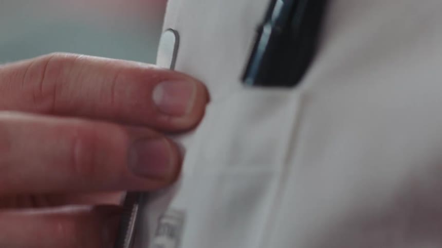 A person removes a tweezers from a pocket