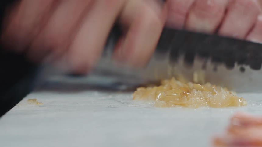 Close up view of a person chopping food