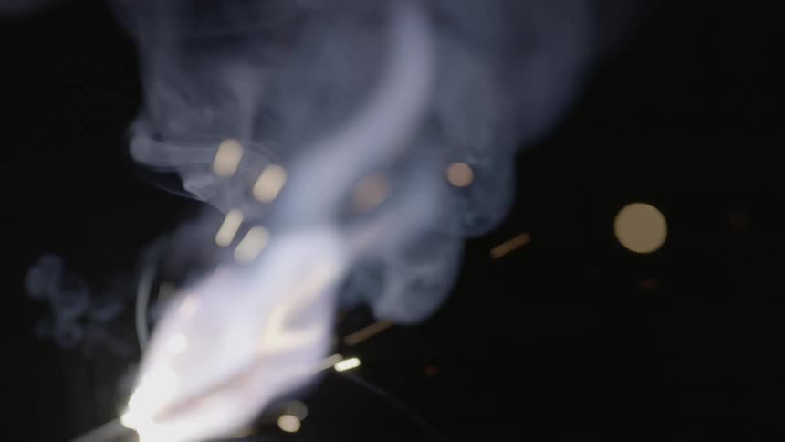 Sparks and smoke fly through the air