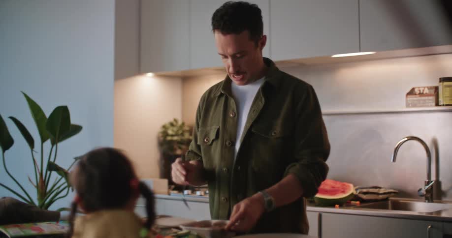A father making food for his daughter