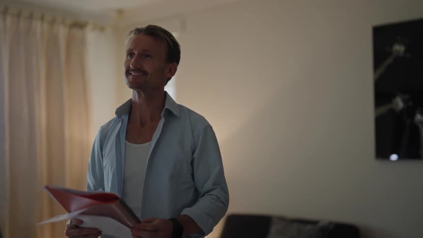 A man paces while practicing a speech in his living room