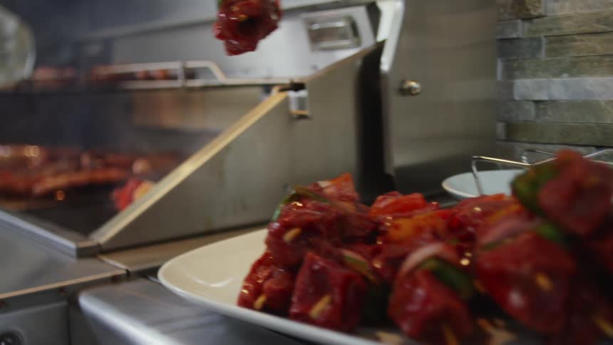 Beef kabobs are placed on an outdoor grill