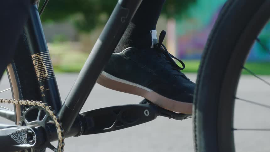 A close up of a person sneaker on a bike pedal