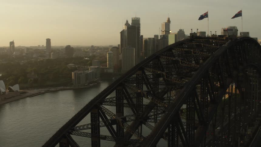 An aerial panning of a bridge going into the city
