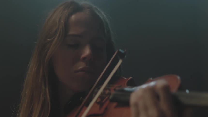 Several people playing their stringed instruments