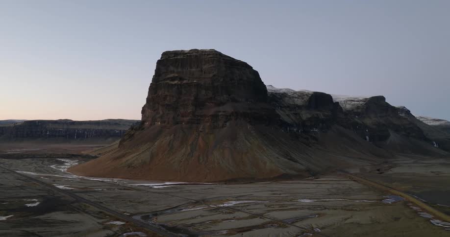 A wide mesa is surrounded by dirt fields