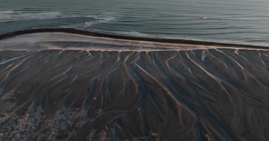 A stunning view of a very large sea with sandy hills in the foreground