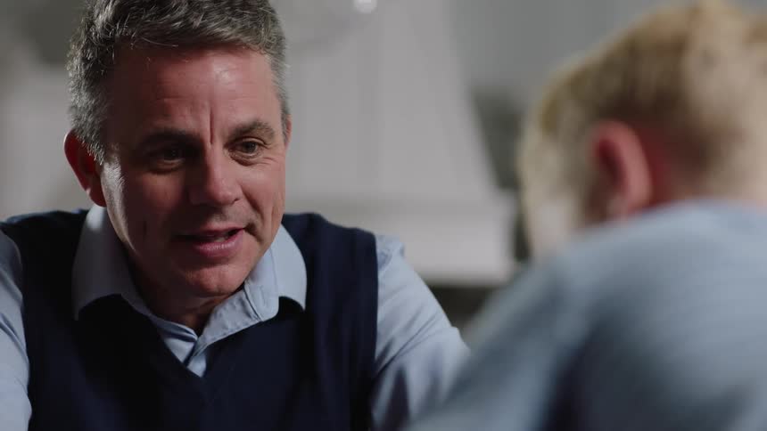 Man smile while talking with young offspring
