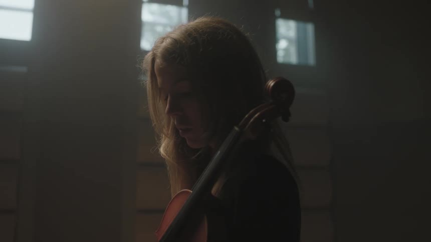 A woman is holding a musical instrument
