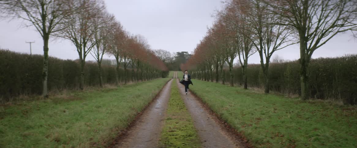 A man runs down the trail