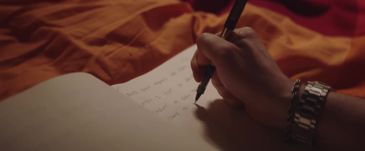 A person is writing in a notebook