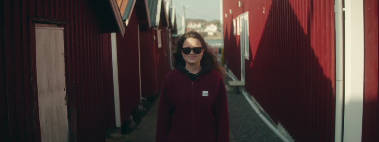 A teenager is smiling in the alley