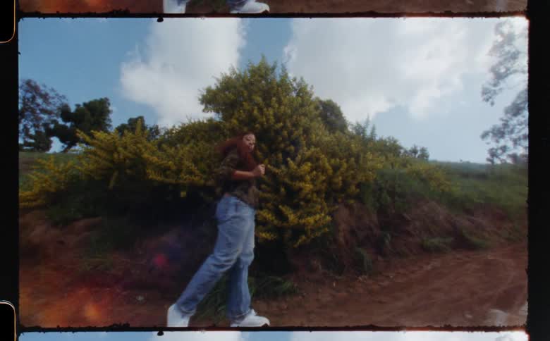 A woman is dancing by the hill