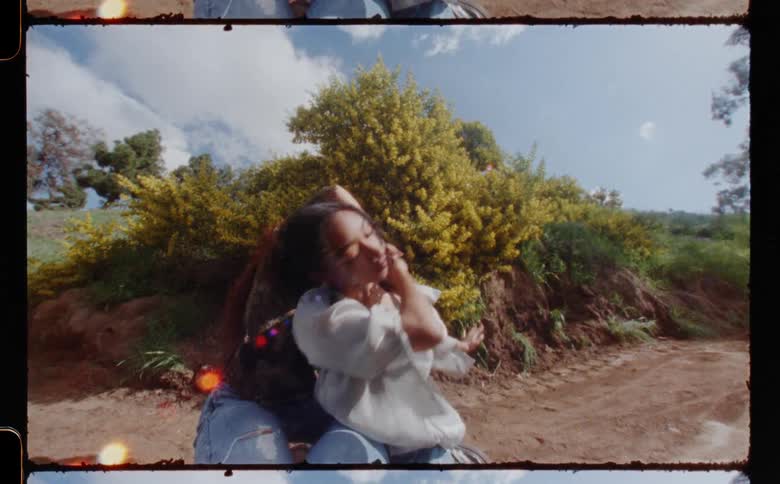 A film of two teenage girls dancing outside
