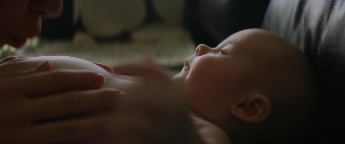 Mother caresses and teases her babys stomach