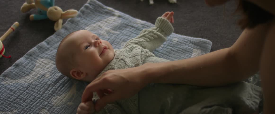 Mother and baby enjoying diaper change time baby cooing and smiling