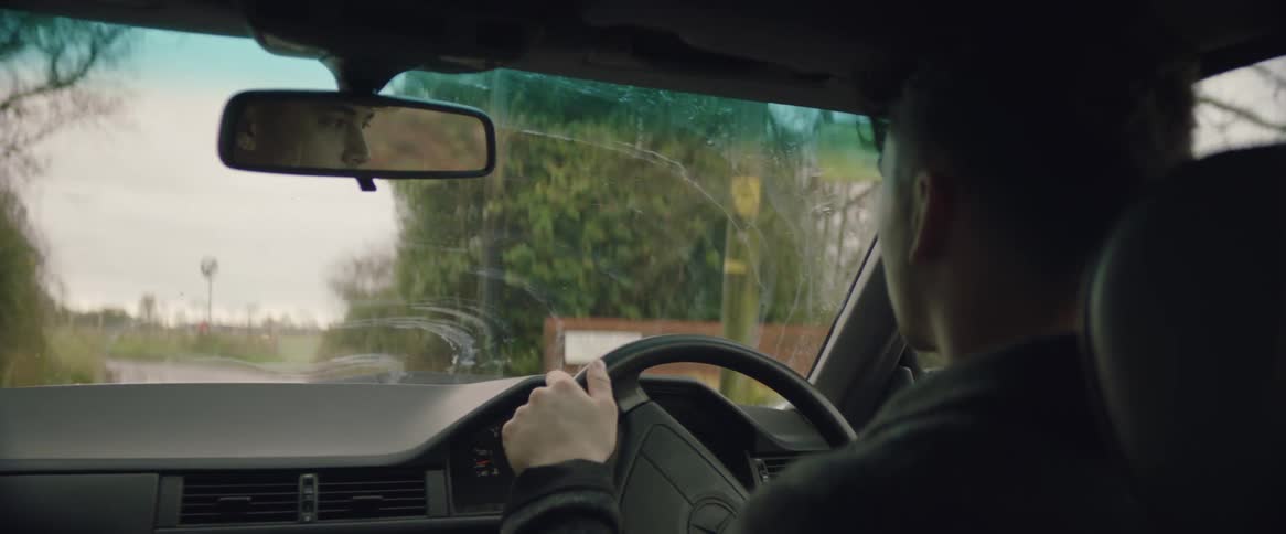 The indoor of a car as a man drives it